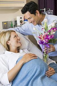 Man Giving His Pregnant Wife Flowers