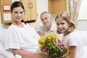 Daughter And Father Visiting Mother In Hospital