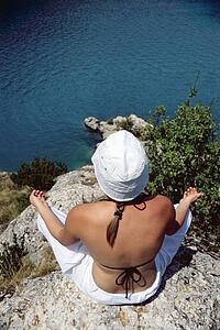 Woman outdoors doing yoga on cliff