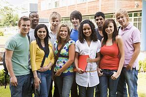 Group of students outdoors looking at camera smiling