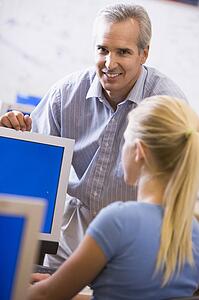 Teacher with female student in computer class