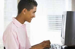 Teenage Boy Using Desktop Computer