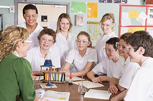 Students receiving chemistry lesson in classroom