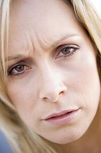 Head shot of woman scowling