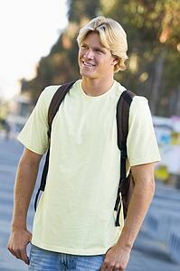 Man standing outdoors smiling (selective focus)