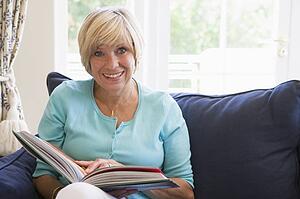 Woman with a book smiling