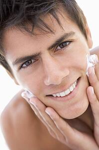 Man putting on shaving cream smiling