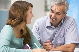 Teacher giving personal instruction to female student