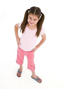 Young girl standing with hands on hips smiling