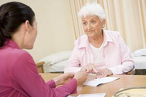 Woman in doctor's office frowning