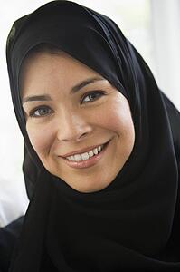 Woman standing indoors smiling (high key)
