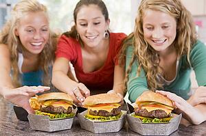 Teenage Girls Eating Burgers 