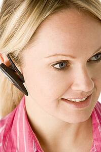 Businesswoman Talking On Hands Free Phone 