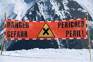 Danger sign on snowy mountain (selective focus)