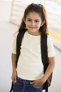 Student standing outdoors smiling (high key)