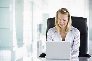 Businesswoman in office using laptop