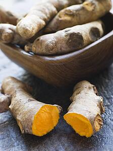 Pieces of Whole And Cracked Fresh Turmeric Root