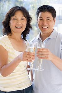 Couple toasting champagne and smiling