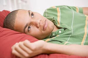 Teenage Boy Lying On Bed