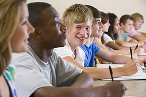 Students in class paying attention and taking notes (selective focus)