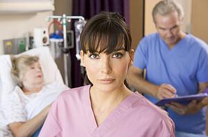 Nurse Standing In Hospital Room, Doctor Making Notes About Patient