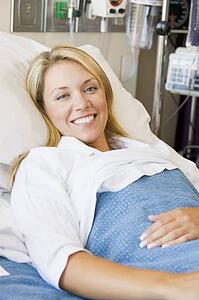 Woman Smiling, Lying In Hospital Bed