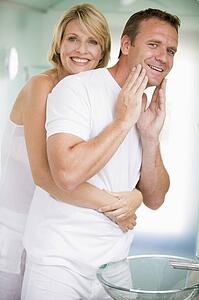 Couple in bathroom embracing and smiling
