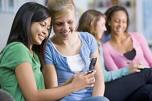 Female students looking at a mobile phone