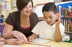 Student in class with teacher learning numbers