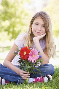 Young girl holding flowers and smiling