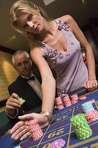 Couple in casino playing roulette (selective focus)