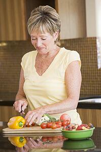 Woman Cutting Up Vegetables