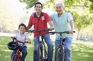 Grandfather son and grandson bike riding.