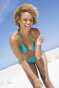 Young woman in a two piece bathing suit on a beach