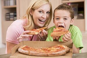 Mother And Son Eating Pizza Together