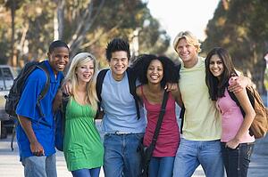 Six people outdoors standing arm in arm together (selective focus)