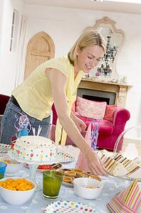 Woman at party setting out food and smiling