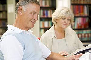 Man and woman in library reading (selective focus)