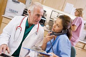 A Doctor And Nurse At The Reception Area Of A Hospital