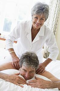 Man receiving a massage from a woman