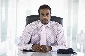 Businessman sitting in office with personal organizer
