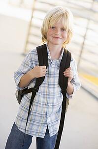 Student standing outdoors smiling (high key)
