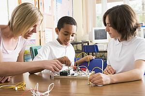Students and teacher in class with electronic project