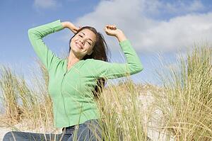 Young woman posing on a sand hill