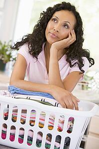 Woman Daydreaming Over Washing Basket 