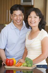 Husband And Wife Preparing meal, mealtime Together