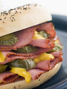 Poppy Seed Bagel with Pastrami Mustard and Gherkins