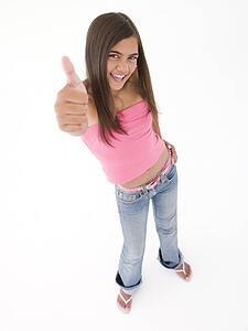 Young girl giving thumbs up smiling