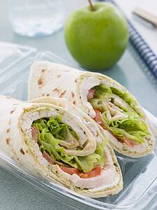 Chicken Salad Tortilla Wrap With A Green Apple And Water
