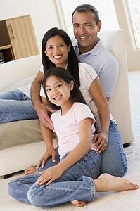 Family in living room smiling
